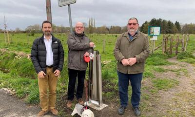 Koen Daniëls en gemeenteraadsleden uit De Klinge bij hondenpoepvuilbak